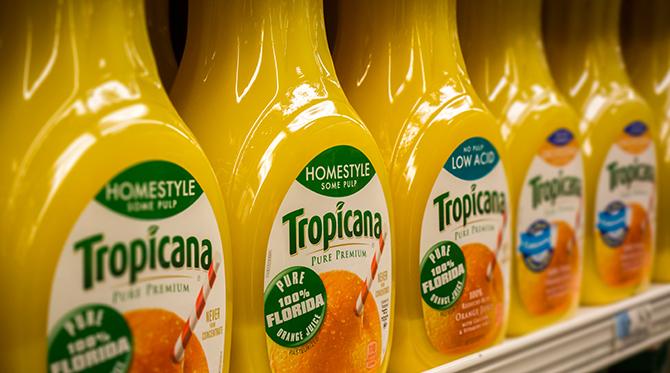 Bottles of Tropicana orange juice are seen in a supermarket refrigerator case